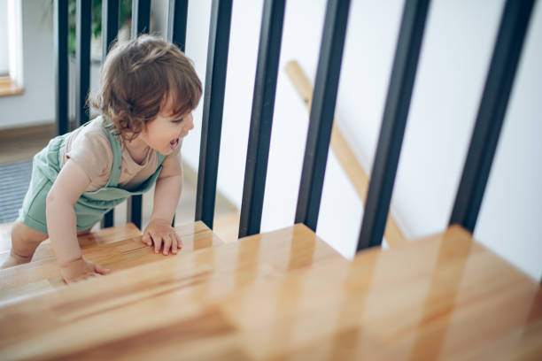 istock Little boy climbing on stairs at home 1503372315