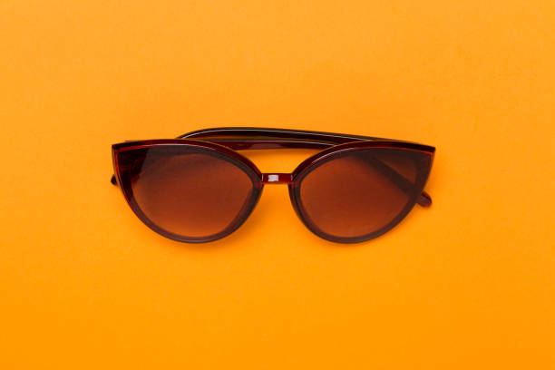istock Sunglasses on color background, top view. 1503372490