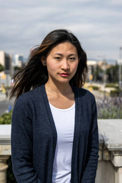 istock Young beautiful confident woman looking at camera standing outdoors. Determined lady staring at camera in a casual style in the street. 1503373036