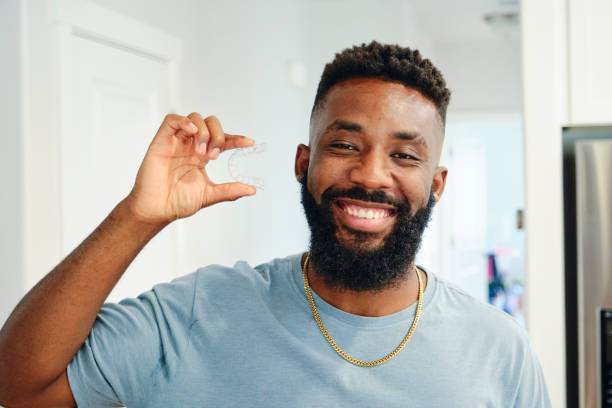 istock Young Man Holding Invisible Dental Aligners 1503374882