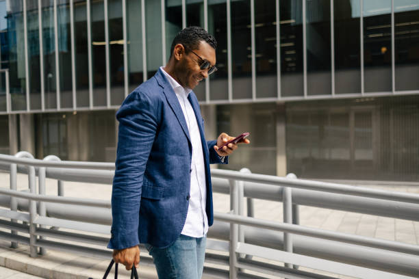 istock Man walking through financial area with smartphone 1503378583