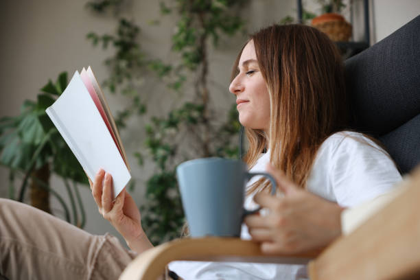 istock Woman reading book and drinking coffee 1503382061