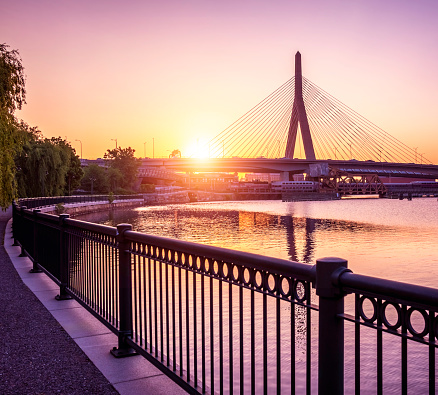 At sunrise, the historic architecture of Boston in Massachusetts, USA with the iconic Zakim Bridge by the TD Garden in the Backbay.