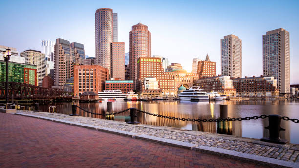 Boston in Massachusetts, USA The Boston Harbor and Financial district in Boston, Massachusetts, USA at sunrise showcasing its mix of contemporary and historic buildings. massachusetts stock pictures, royalty-free photos & images