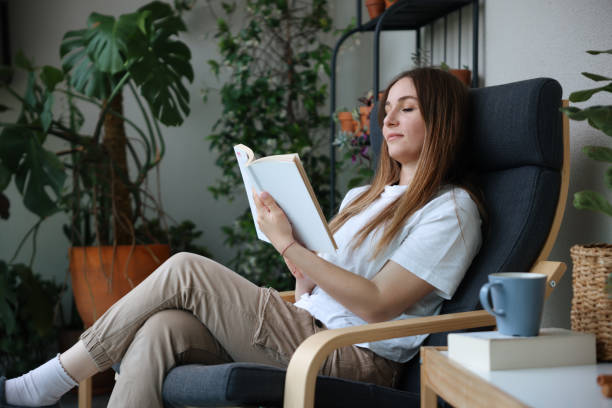 istock Woman reading book and drinking coffee 1503382792