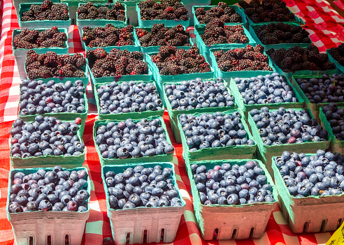 cartons of farmer's market blueberries and blackberries