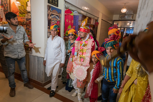 Jodhpur,Rajasthan,India - 19.10.2019 : Groom wearing garland of money, ready for Baraat or procession to reach the wedding venue with family members and friends. Sindhi marriage ceremony in hotel.