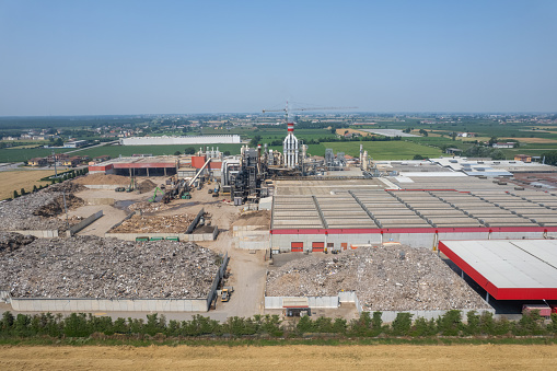 Pomponesco, Italy - June 20 2023 Aerial view of Controlled harvesting of raw material, technologically advanced melamine chipboard and mdf production plants.