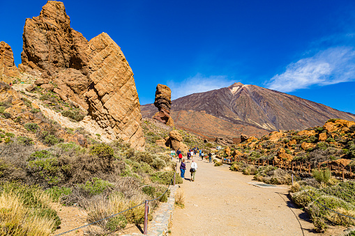 Tenerife,Canary island,Spain 07 March 2023:Tourists walking along a track towards Roque Cinchado and Mount Teide