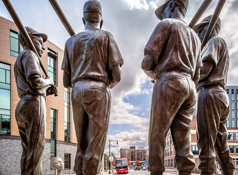 Boston, MA, USA - March 5, 2023: the historic architecture of the Fenway Park Stadium showcasing the statues of its famous players standing outside of one of the gates in Boston, MA, USA.