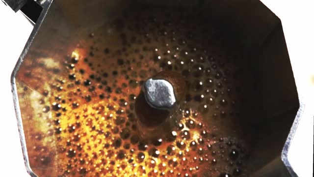 Close Up Coffee Espresso Boiling Classic Moka Pot Homemade Coffee. Italian Mocha Coffee. Machine Black Coffee Hot Warm Steaming Americano Top View.