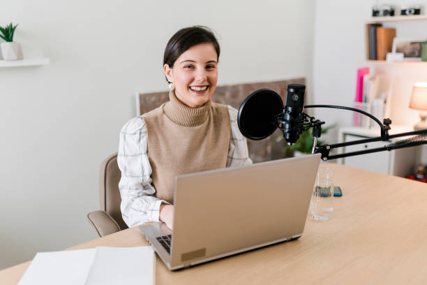 istock Young smiling women recording podcast and doing live streaming using microphone and headphones in recording studio 1503390233