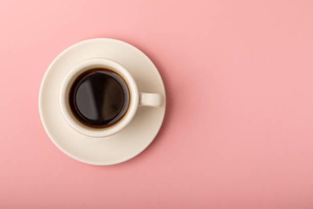 istock Hot coffee in a white coffee cup on a colored background.Hot warming drink concept.Copy space.Top view.Place for text. 1503391710