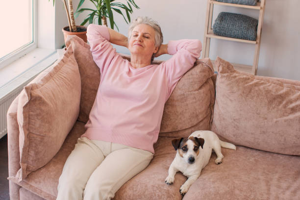 istock Relaxed satisfied older woman sitting leaning back on couch 1503391903