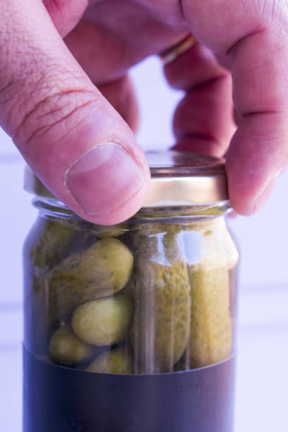 istock Mature man closing jar of pickled cucumbers 1503392287