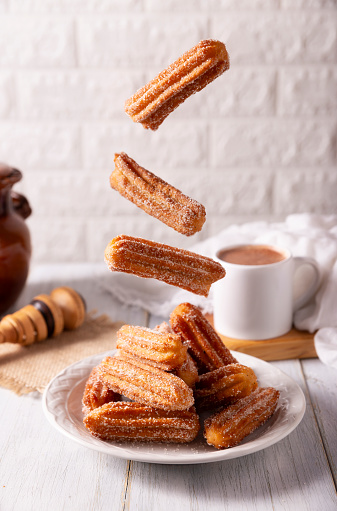 Falling Churros. Fried wheat flour dough, a very popular sweet snack in Spain, Mexico and other countries where it is customary to eat them for breakfast or accompanied by hot chocolate.