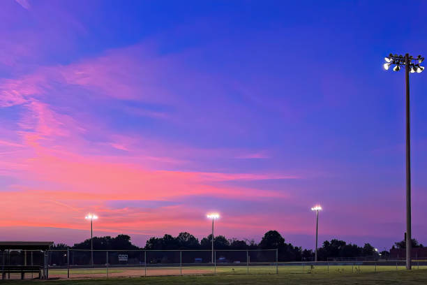 istock Pink and purple sky over lighted baseball park 1503393582