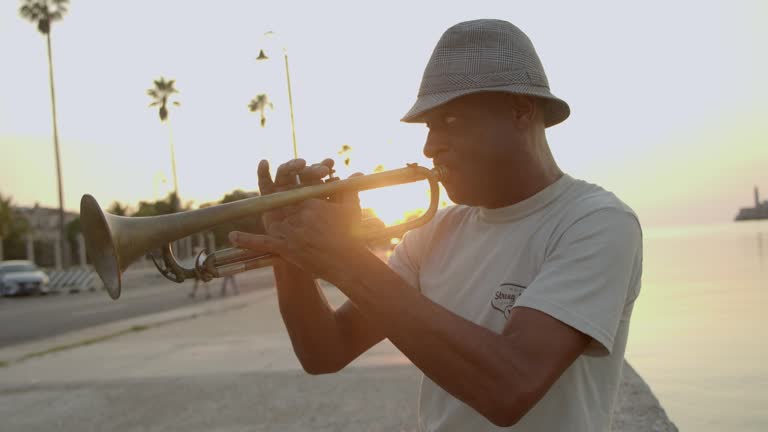 Mature man playing the trumpet on the streets of Havana, Cuba