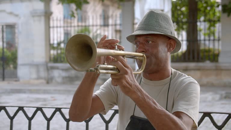 Mature man playing the trumpet on the streets of Havana, Cuba