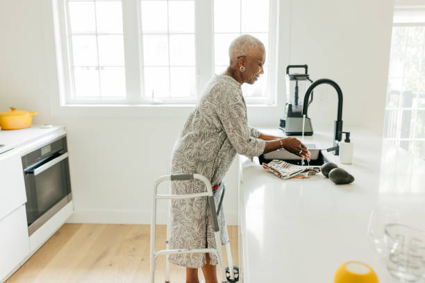 istock Senior women washing hands in the kitchen 1503398422