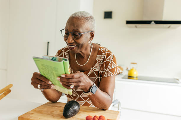Senior women reading a magazine at home