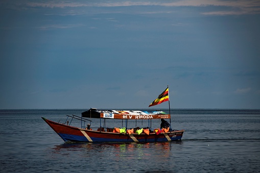 Entebbe, Uganda - 06 24 2023, traditional tourist boat moving past on Lake Victoria in Uganda