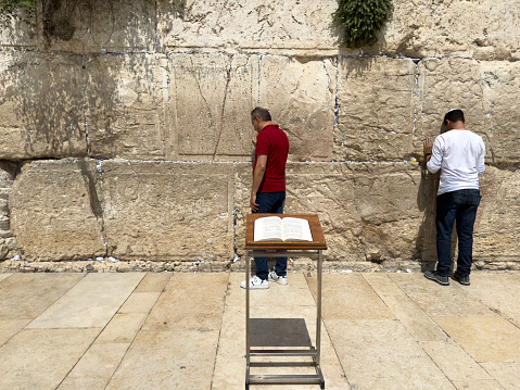 Orthodox Jewish man praying alone at the Wailing Wall in Jerusalem, Israel.