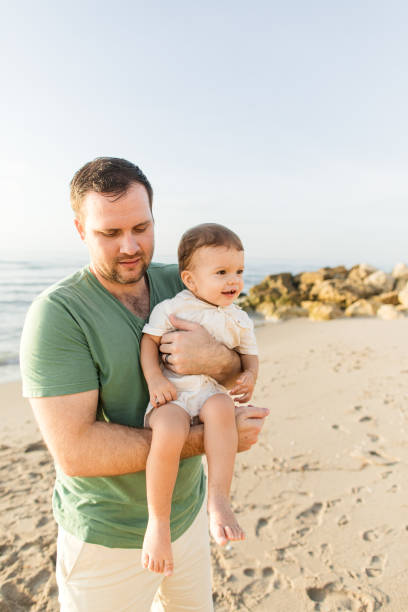 istock A 31-Year-Old American Father Holding His 1-Year-Old Son While Enjoying Time Together During a Golden Sunrise on Palm Beach, Florida in the Summer of 2023 1503414142