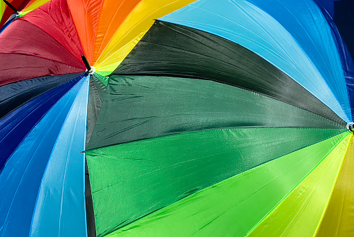 Rainbow umbrellas outdoors at a lgbtqia event