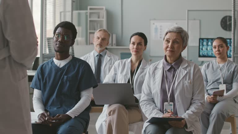 Group of Doctors Listening to Professor at Medical Seminar