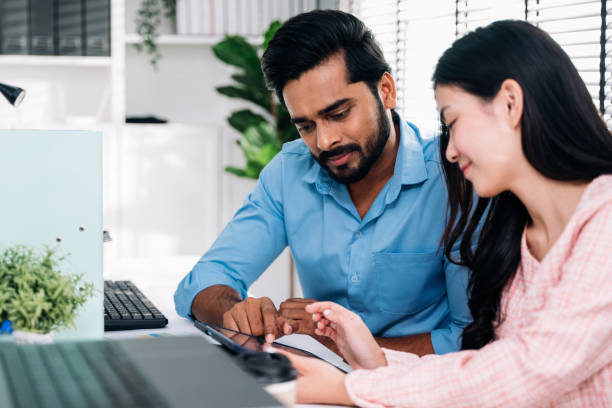istock Businessman and businesswoman using laptop working at modern office 1503421049
