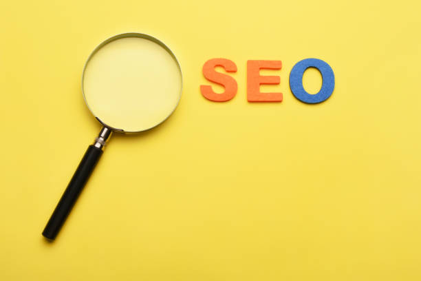 istock SEO concept. Search engine optimization. A magnifying glass and word seo on the yellow background 1503421219