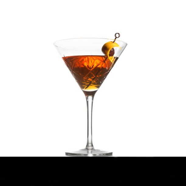 istock the manhattan cocktail is served on the table, with cherries and a slice of 1503424763