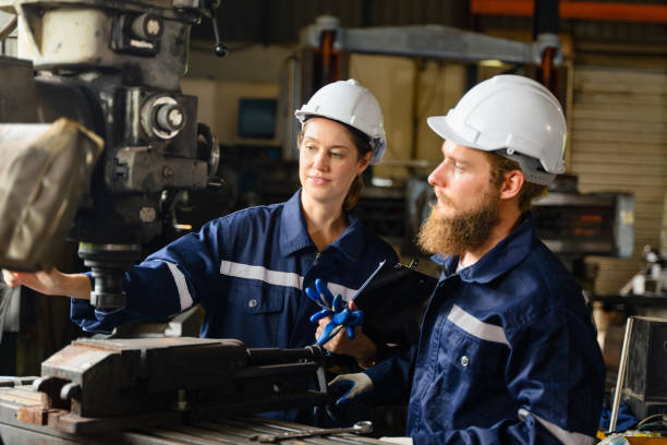 istock Mechanical engineers repairing engine machine at factory 1503425078