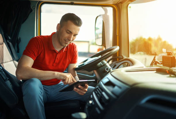 istock Truck driver at a parking lot using digital tablet. 1503429378