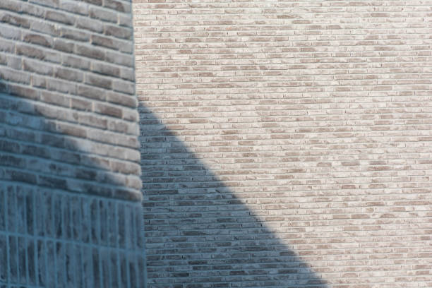 istock Brick white wall with shadow,walls on which a diagonal shadow falls, shadow light on the wall 1503445457