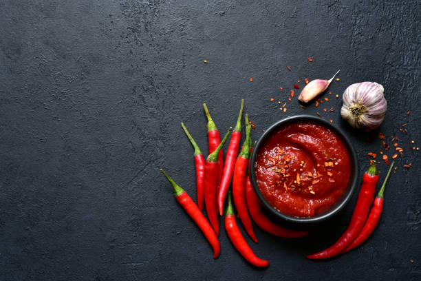istock Spicy asian dip harissa with roasted red pepper and garlic.Top view with copy space. 1503445855