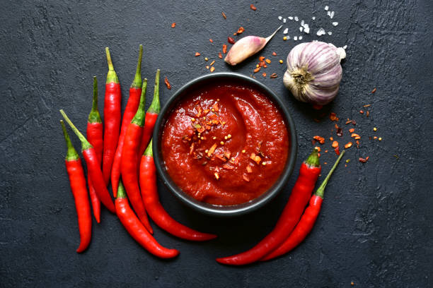 Spicy asian dip harissa with roasted red pepper and garlic.Top view with copy space. stock photo