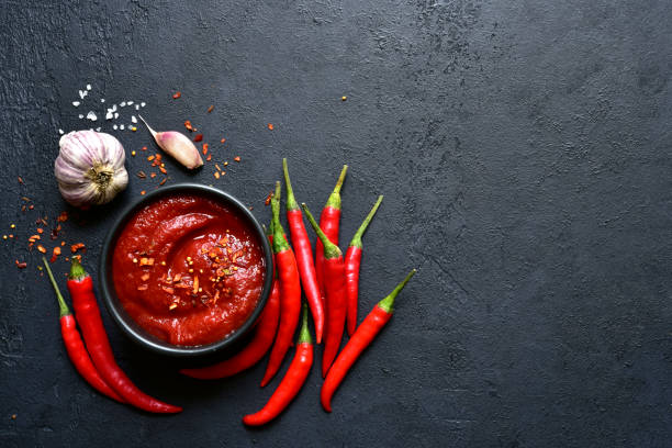Spicy asian dip harissa with roasted red pepper and garlic.Top view with copy space.
