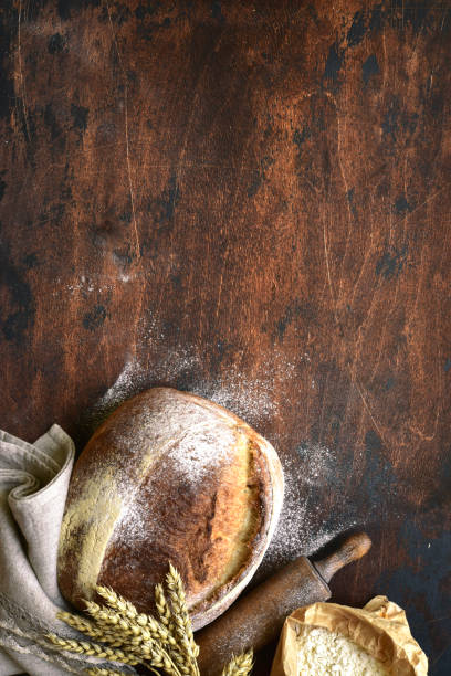istock Homemade fresh baked bread with flour and ears. 1503448379