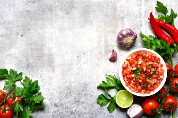 istock Tomato salsa (salsa roja) - traditional mexican sauce  with ingredients for making .Top view with copy space. 1503448648