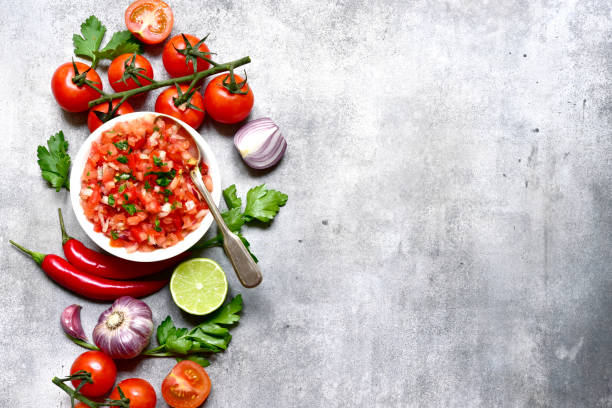 istock Tomato salsa (salsa roja) - traditional mexican sauce  with ingredients for making .Top view with copy space. 1503448727