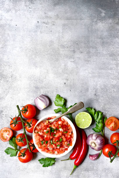 istock Tomato salsa (salsa roja) - traditional mexican sauce  with ingredients for making .Top view with copy space. 1503448728