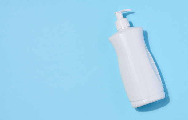 istock White plastic container with a pump for liquid products on a blue background. Container for cosmetics, soap, cream 1503449987