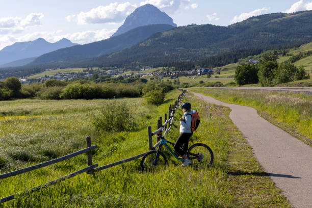 istock Senior female mountain biker pauses beside paved pathway 1503450816