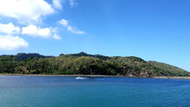 istock Beautiful background of Widara Payung Beach Cilacap Central Java with green hill and blue sky for wallpaper 1503454720