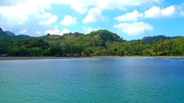 istock Beautiful background of Widara Payung Beach Cilacap Central Java with green hill and blue sky for wallpaper 1503454740