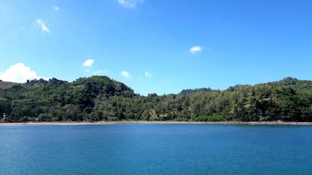 istock Beautiful background of Jetis Beach Cilacap Central Java with green hill and blue sky for wallpaper 1503454822