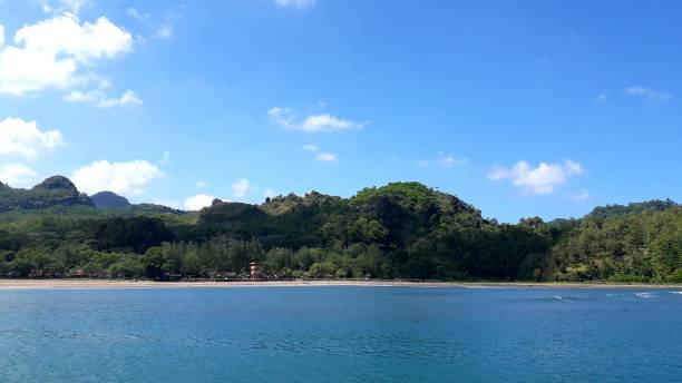 istock Beautiful background of Jetis Beach Cilacap Central Java with green hill and blue sky for wallpaper 1503454854