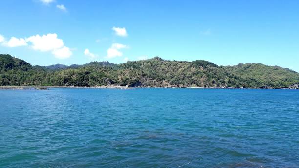 istock Beautiful background of Jetis Beach Cilacap Central Java with green hill and blue sky for wallpaper 1503454934